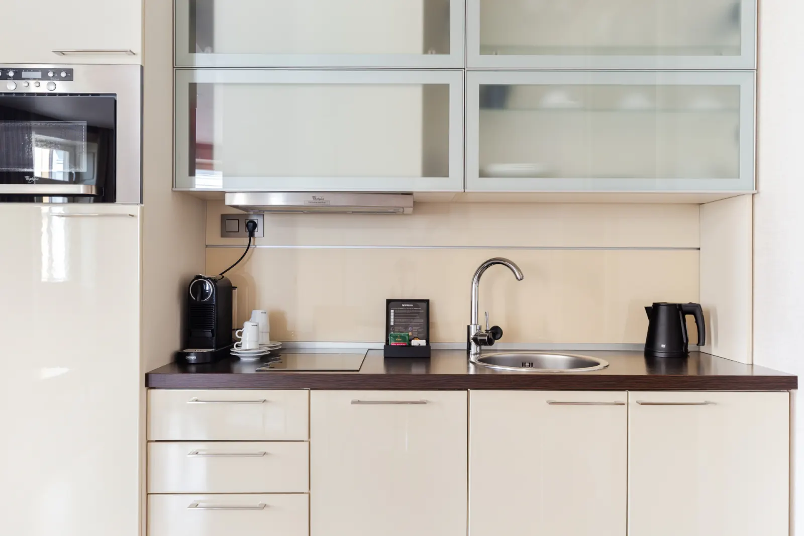 Deluxe Suite kitchenette with Nespresso, induction hob, sink and upper cabinets