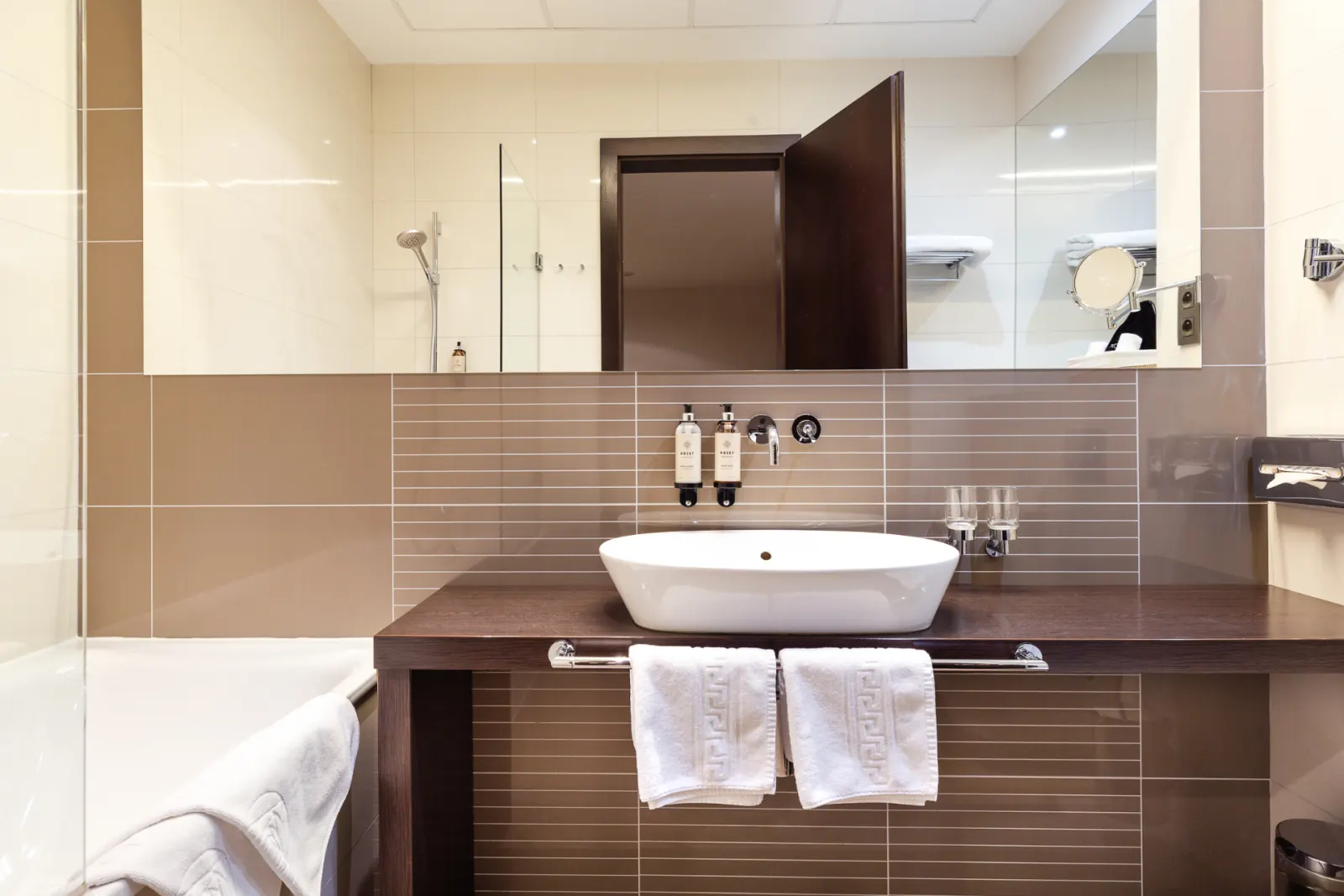 Executive Suite bathroom with bath, vanity and Roset amenities