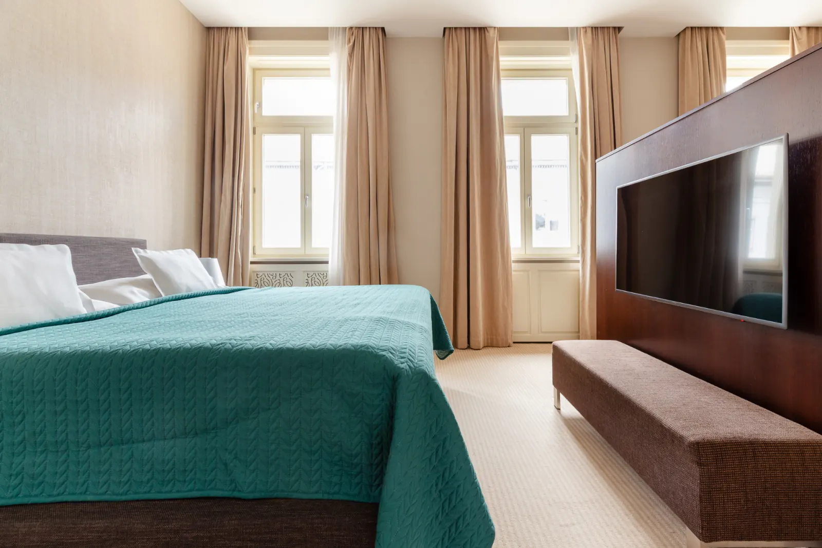 Executive Suite bedroom with king bed and tall arched windows