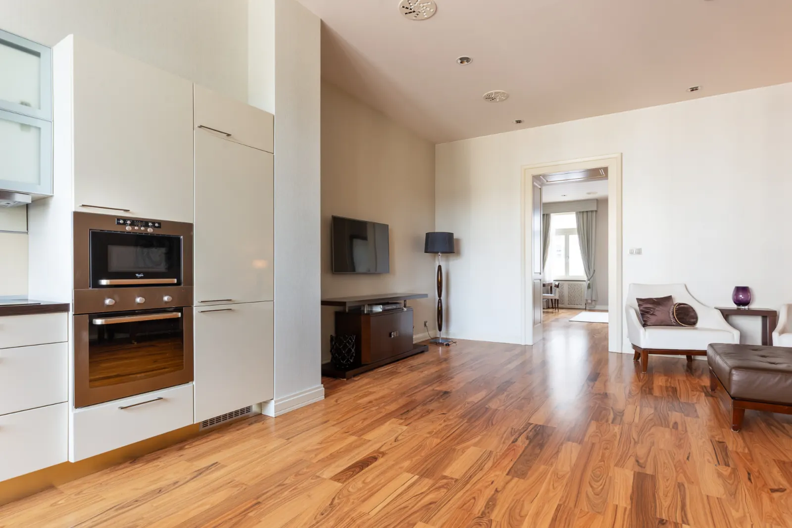 Luxury Suite open-plan living area with full kitchen and LED TV
